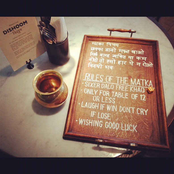 Dishoom's matka board - if you roll a six on the dice you get the meal for free
