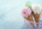 3 ice cream cones propped up in a metal basket