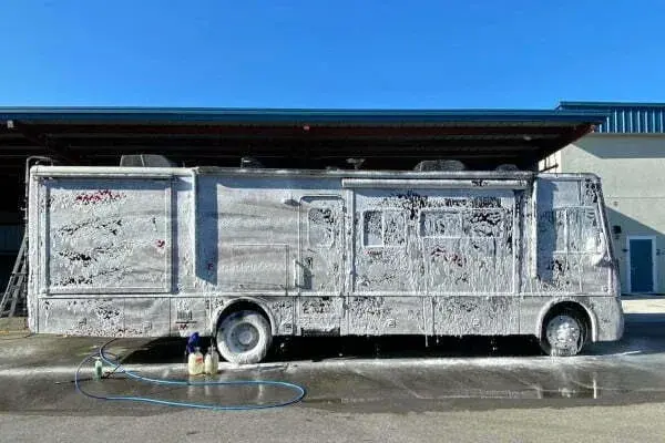 Exterior RV wash removing dirt and road grime during professional detailing