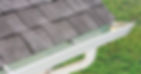 White gutter installed on gray shingled roof