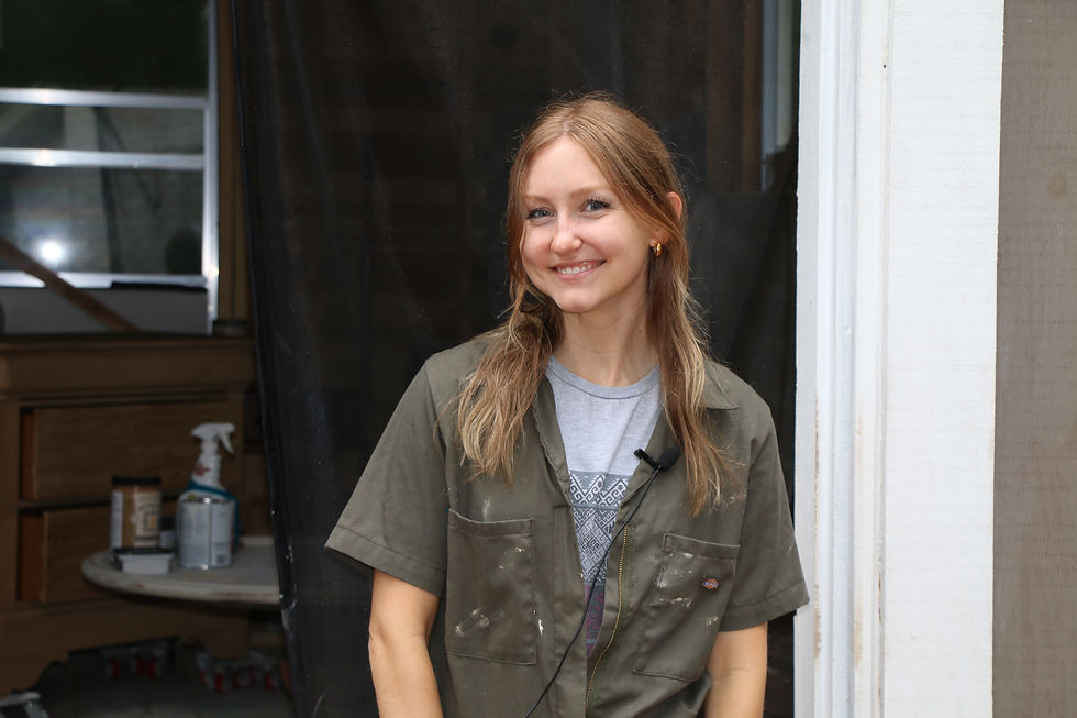 Laura Valk, Restored by Laura, smiling in front of her workshop, showcasing her passion for furniture restoration and flipping.