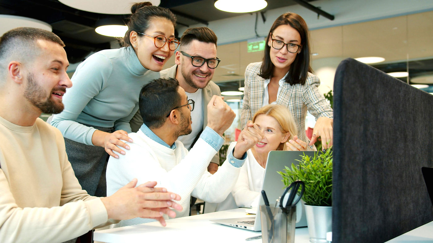 Multi-ethnic team women and men are talking clapping hands doing high-five celebrating ach
