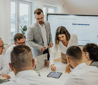 a group of people sitting around a table with laptops_edited.jpg
