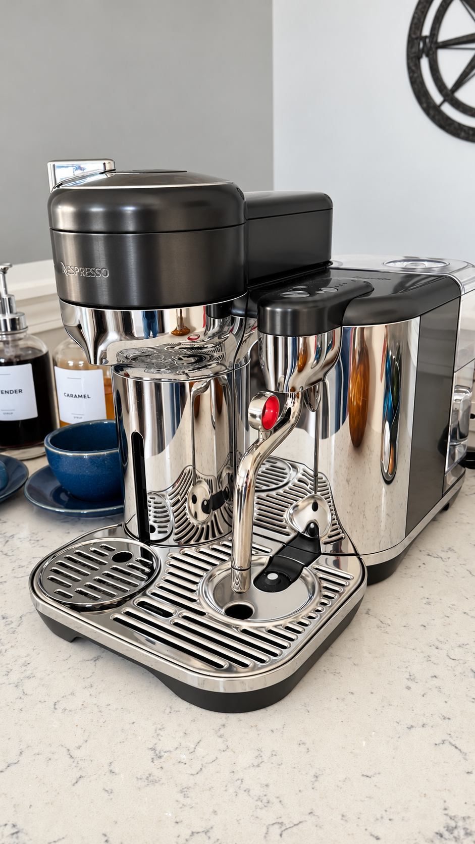 Close-up of our Nespresso Vertuo Creatista showing the coffee outlet, steam wand, and drip tray