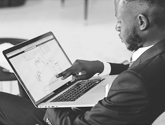 A man pointing at his laptop screen_edit