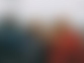 Three friends looking through a telescope over a city