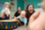 Kindermusik-2017_toddler_boy_with_teacher_playing_drums-1024x683