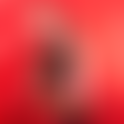 A tender scene featuring a couple embraced amidst vibrant red roses and exotic blooms. The man holds a small bouquet of roses, while the woman gently leans on his shoulder, capturing the essence of passionate love.