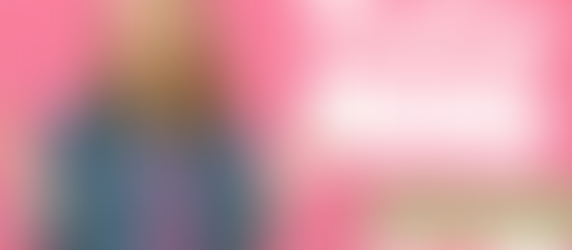 Woman shrugging in denim jacket over pink dress, pink checkered background. Text: Playing Big, Ep. 26, ft. Jacinthe Koddo.