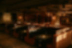 Dimly lit modern restaurant booths with built-in grills.