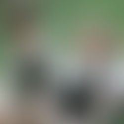 two girls smiling in a garden