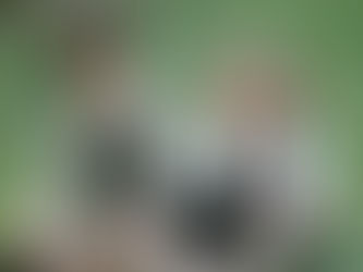 two girls smiling in a garden