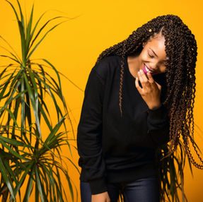 a woman with indoor plants and bright yellow background