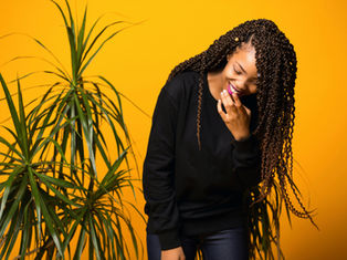 a woman with indoor plants and bright yellow background
