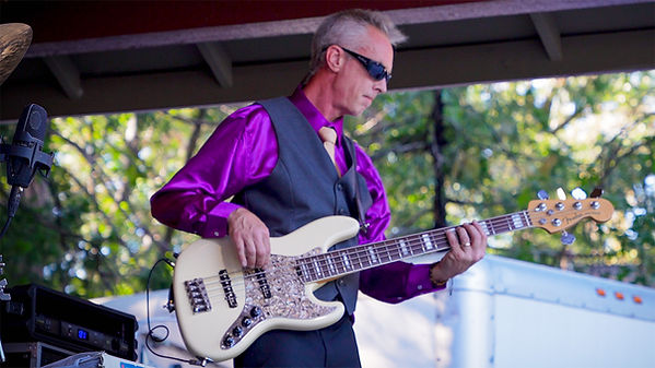 Jason, bass player for The Essentials, known for his pulsive rhythm, infectious stage energy, and signature style.