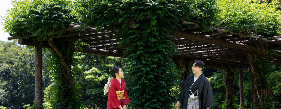 Romantic kimono wedding portrait in a tatami room with a Japanese garden view.