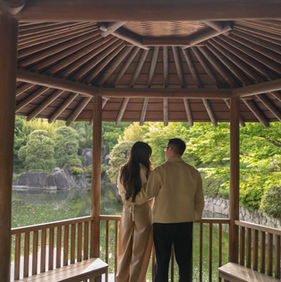 couple standing inside traditional japanese pavilion tokyo garden