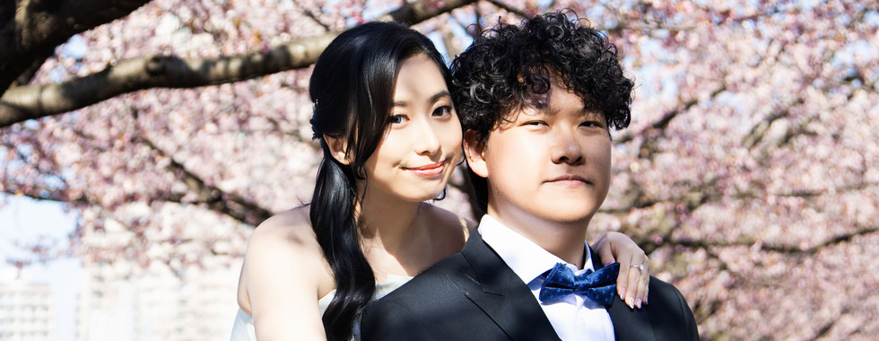 close up romantic couple portrait beneath cherry blossom trees