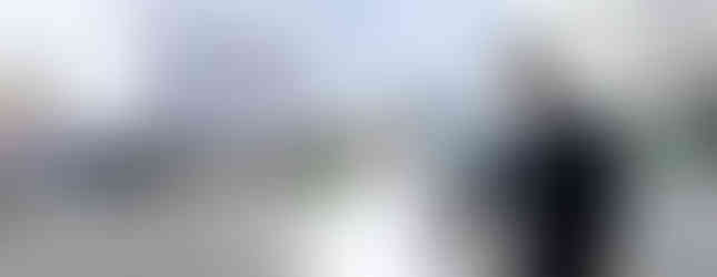 Wedding couple standing together with the Cosmo Clock 21 Ferris wheel and Yokohama skyline in the background.