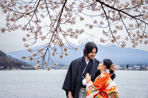 traditional japanese wedding portrait under sakura branches lakeside