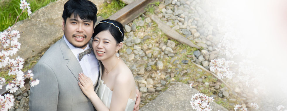 romantic couple portrait beneath cherry blossoms from above