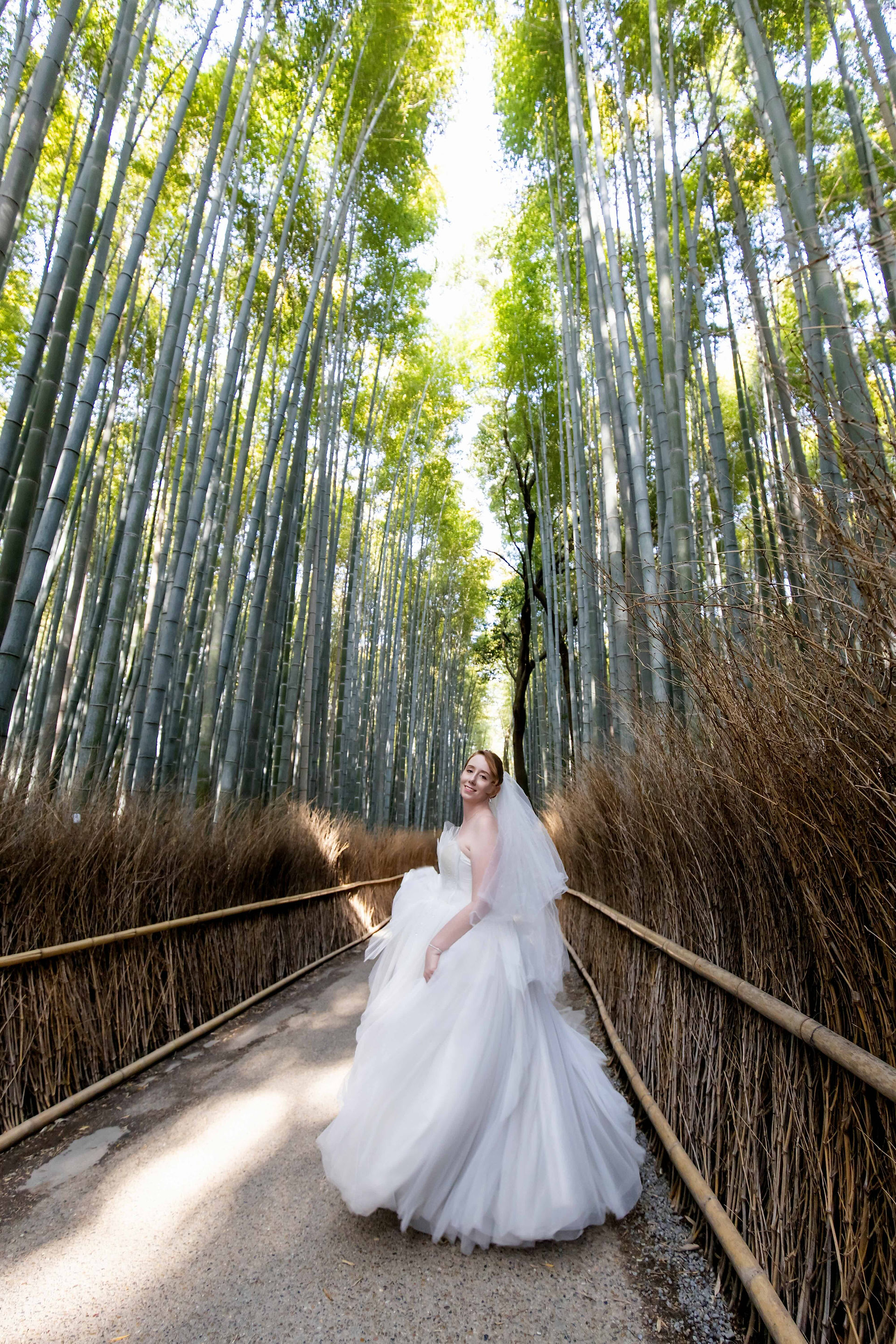 Elegant destination wedding portrait in the serene Arashiyama Bamboo Grove.