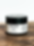Thumbnail: Black Keystone Cream jar with white label on a wooden surface with a white background