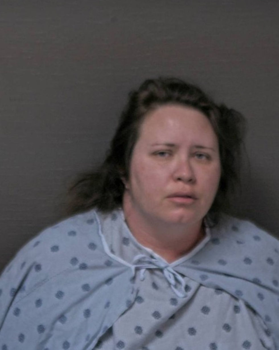 A woman stares ahead