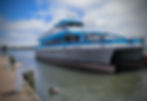 A boat is in the water between docks