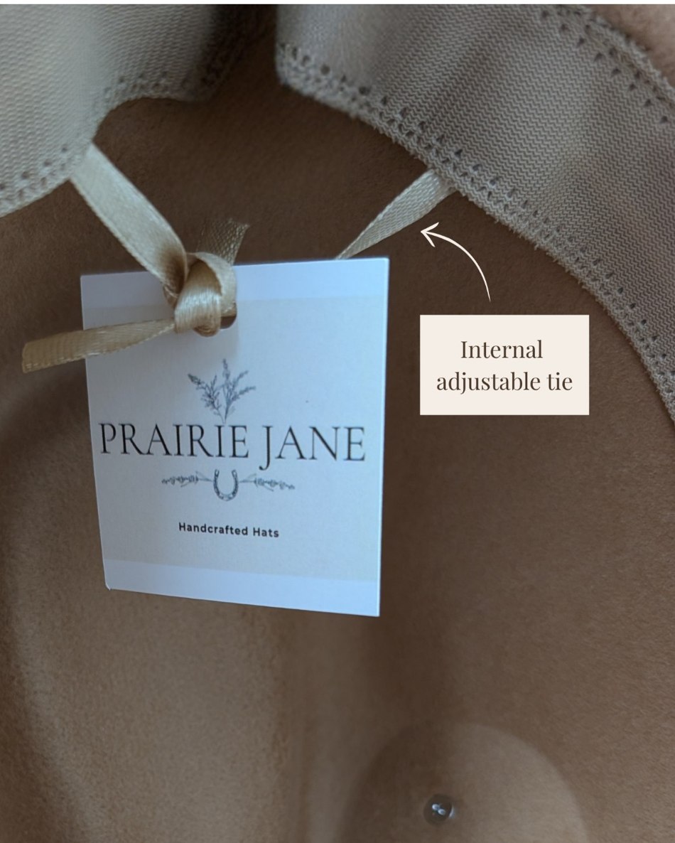 Inside an actual Prairie Jane hat, showing the adjustable satin tie beneath the internal sweatband