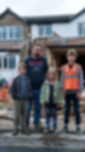 themokko_A_family_standing_in_front_of_their_home_in_the_UK_loo_c733554d-4822-4c49-bf77-8a
