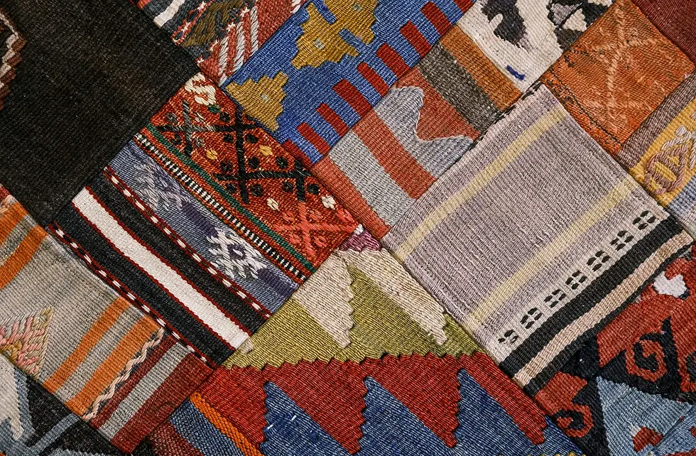 Handcrafted textile patchwork showing layered patterns and textures, reflecting cultural memory, craft, and living heritage.