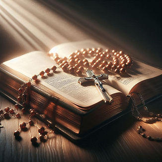 Roman Catholic Rosary beads lying on a Bible with light shining outwards from the beads.jp