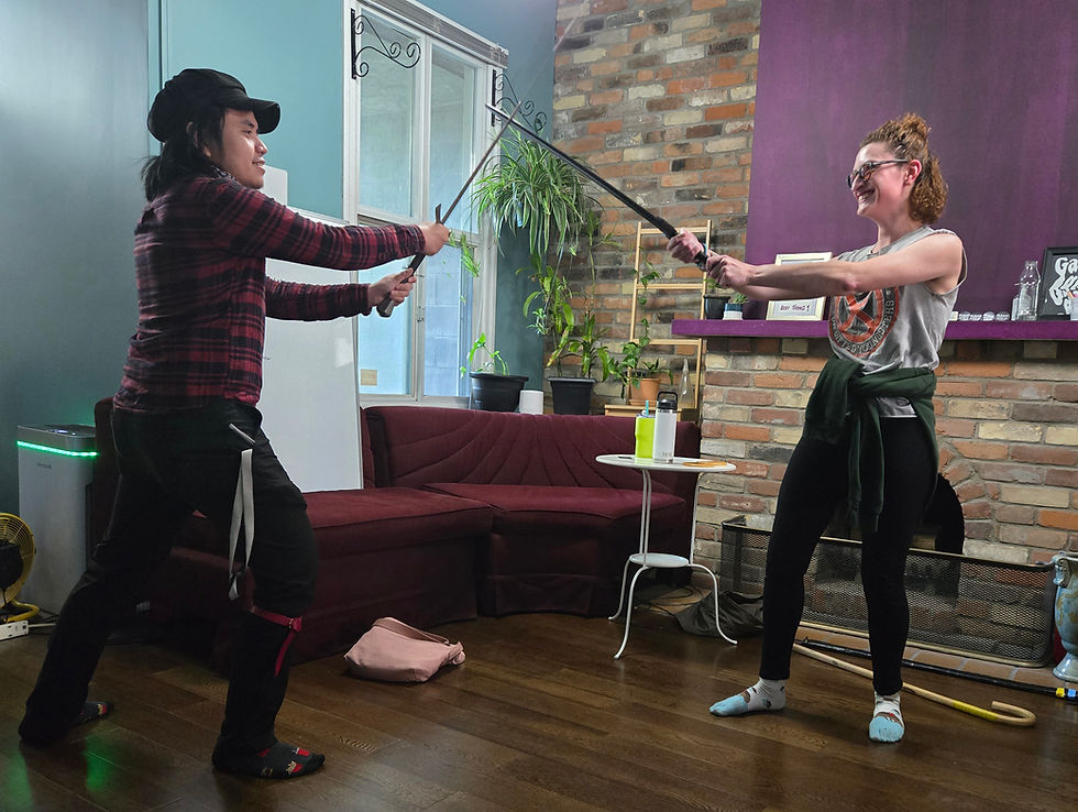 Lounge area and two people doing a sword combat exercise