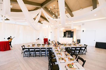 Private event at a venue in Utah with tables and chairs. Custom designed ceiling drape is installed in the ceiling.