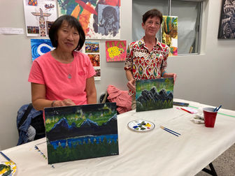 July 15, 2023 Parks Day Paint Party participants proudly display their paintings