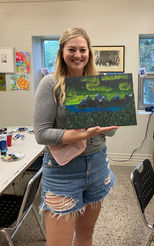 July 15, 2023 Parks Day Paint Party participant proudly shows off her painting