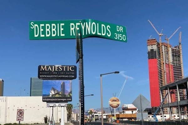 A street sign marker for Debbie Reynolds Drive overlooking the Las Vegas strip