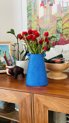 Blue handmade ceramic vase with flowers