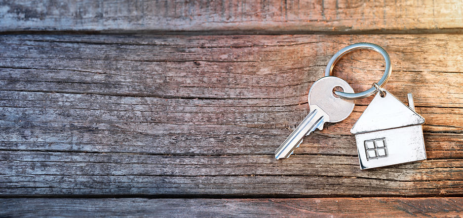 House Key And Keychain On Wooden Table.jpeg