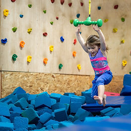 child on gymnastics zipline