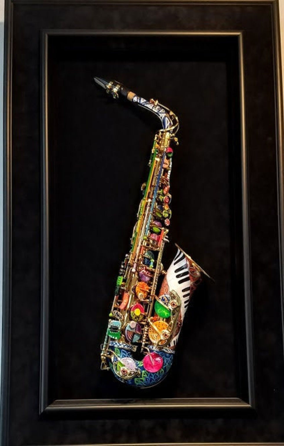 Hand-painted saxophone by artist Sonia Osio displayed as 3D saxophone wall art in a deep black custom shadow box frame.