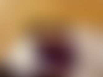 My mum and myself smiling and me hugging her on our white couch, in our lounge. Cozy mood.