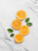 sliced orange fruit on white table_edited_edited_edited.jpg