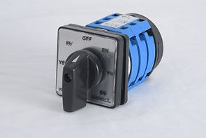 The image shows a Phase selector switch. This type of switch is used to control the operation of electrical circuits by rotating the handle to different positions. The switch has a black handle and a square faceplate with various labels indicating different positions: "RY," "OFF," "RN," "YN," "BN," and "YES." The body of the switch is blue and black, and it appears to be designed for panel mounting. This type of switch is commonly used in industrial and electrical applications to control machinery and equipment.