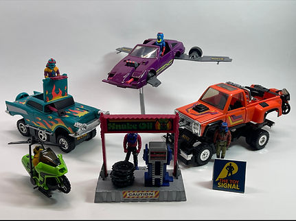 Vintage Kenner M.A.S.K. toys including Thunderhawk, Rhino, Switchblade, Condor motorcycle, and figures displayed with a service station playset.