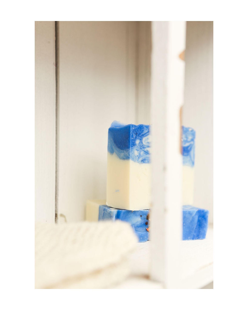 Thumbnail: side view of a blue and white soap bar in a wooden cupboard