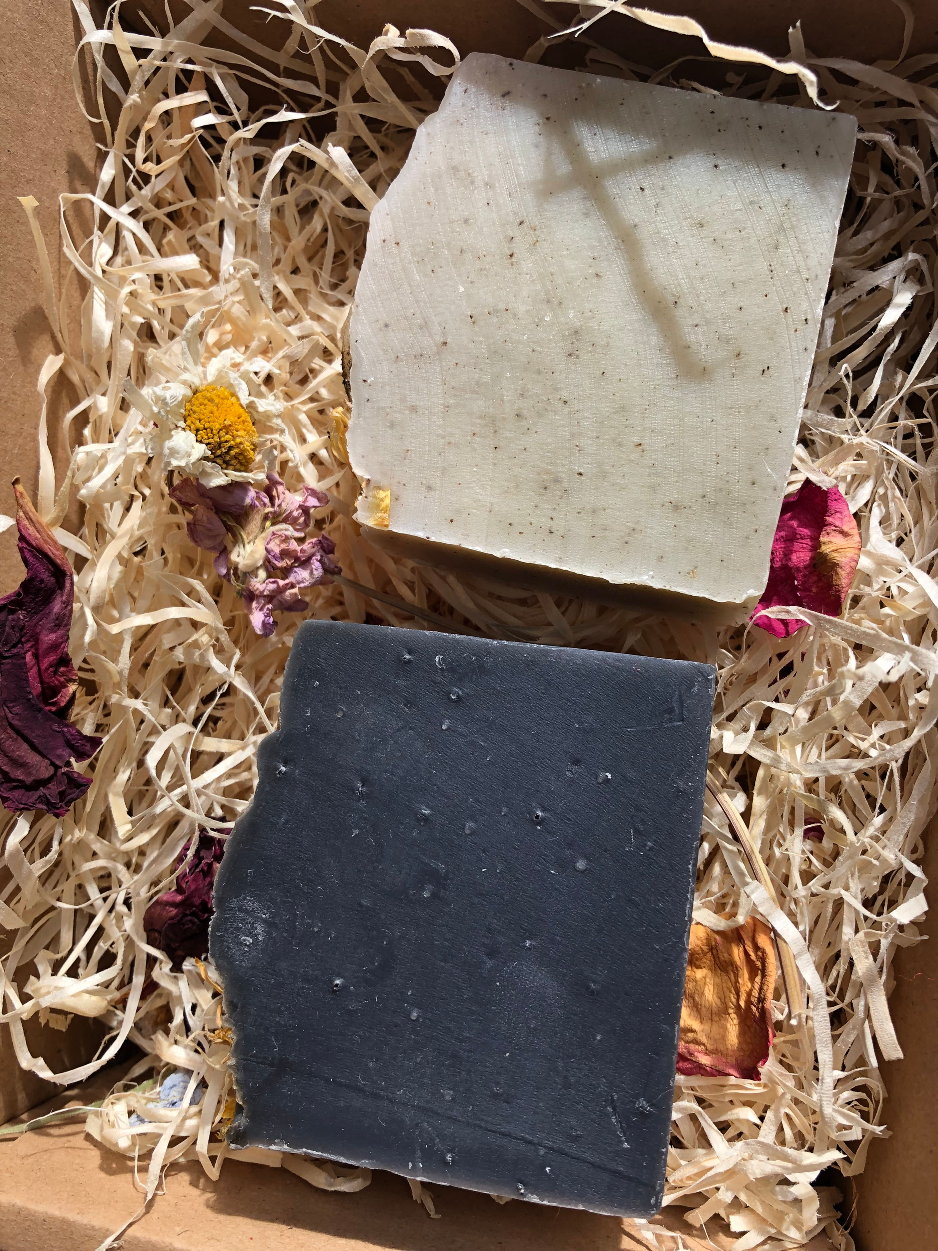 A natural gif box with a black marigold soap and a nettle and peppermint soap within it.