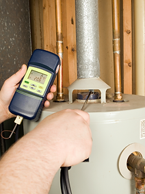 Checking carbon monoxide levels of an appliance with a carbon monoxide detector.