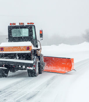 snow plow on snow covered street.jpg